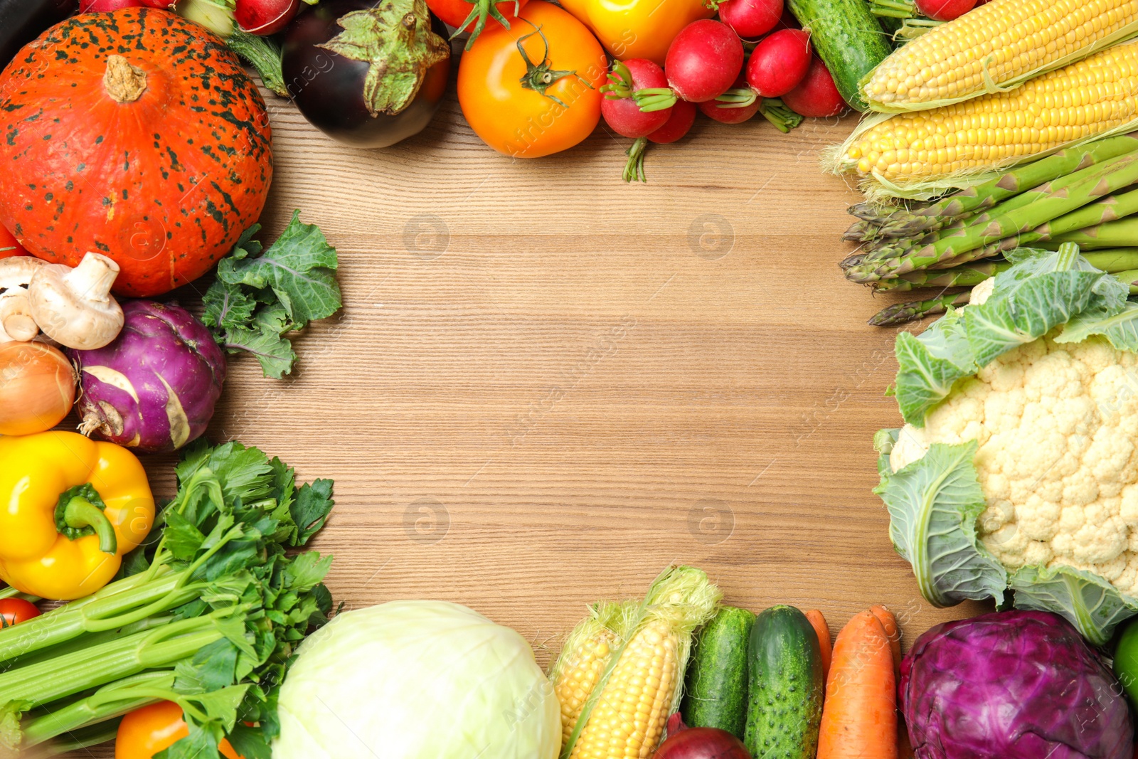 Photo of Flat lay composition with assortment of fresh vegetables on wooden background. Space for text