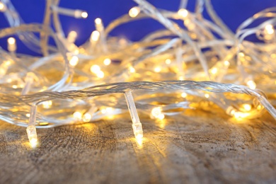 Beautiful bright Christmas lights on wooden table