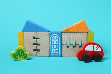 Photo of Set of wooden toys on light blue background. Children's development