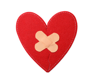 Photo of Red fabric heart with sticking plasters isolated on white, top view