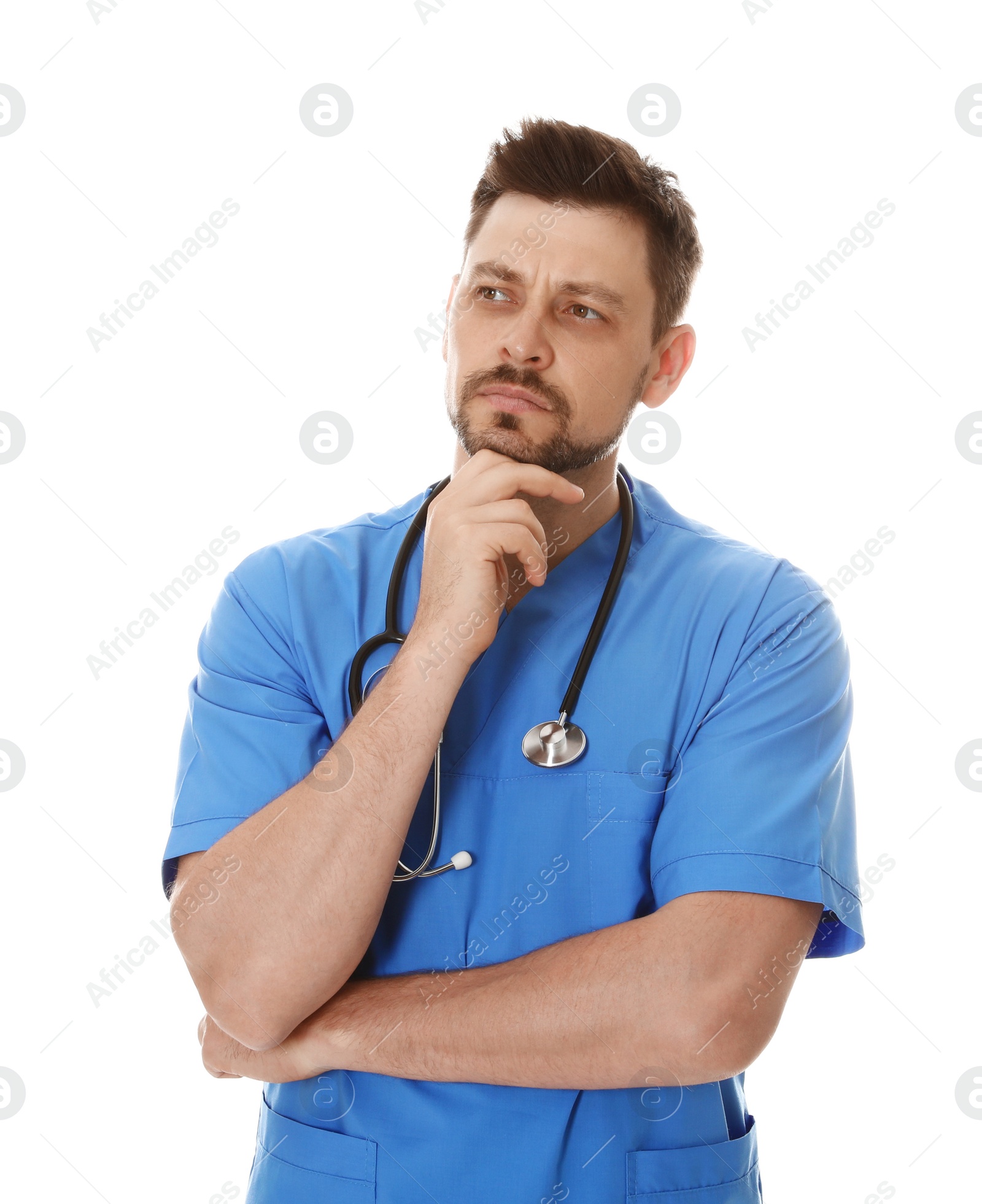 Photo of Portrait of pensive male doctor in scrubs isolated on white. Medical staff