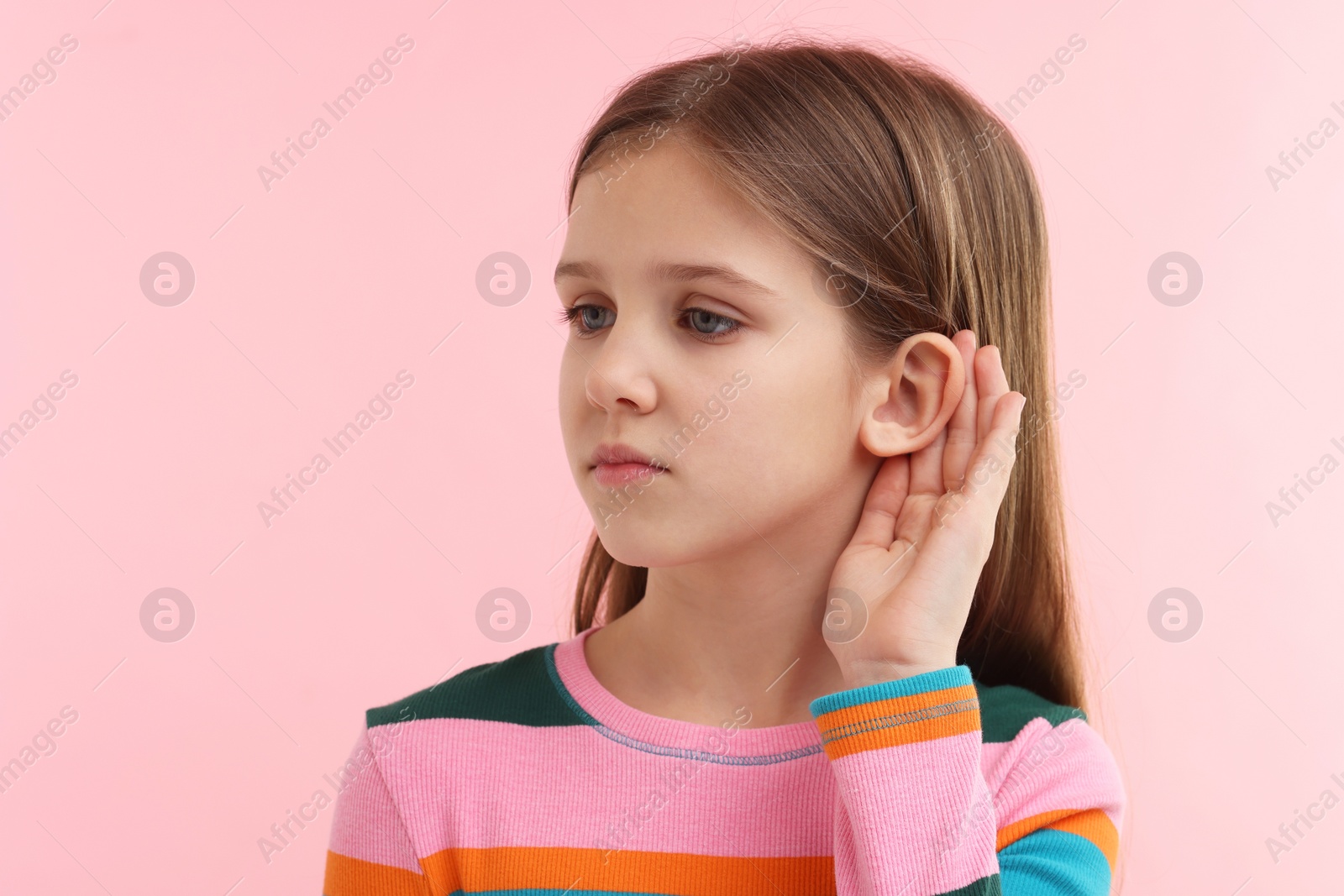 Photo of Little girl with hearing problem on pink background