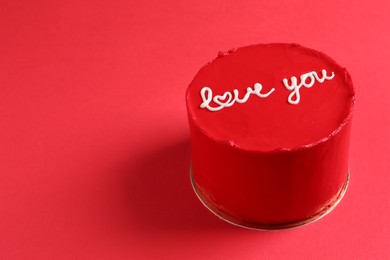 Photo of Bento cake with text Love You on red table, space for text. St. Valentine's day surprise