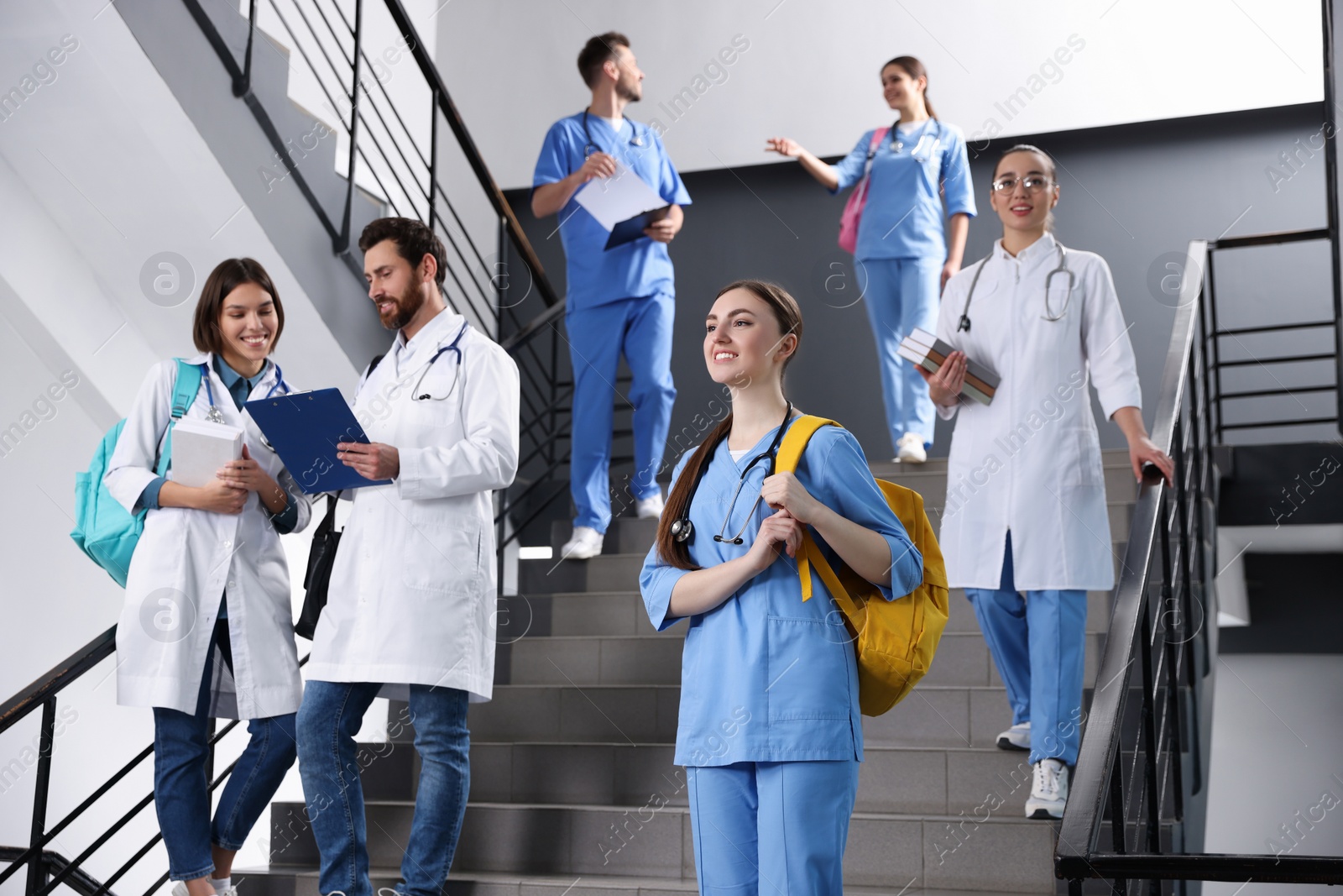 Photo of Medical students wearing uniforms on staircase in college