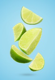 Image of Fresh lime slices falling on light blue background