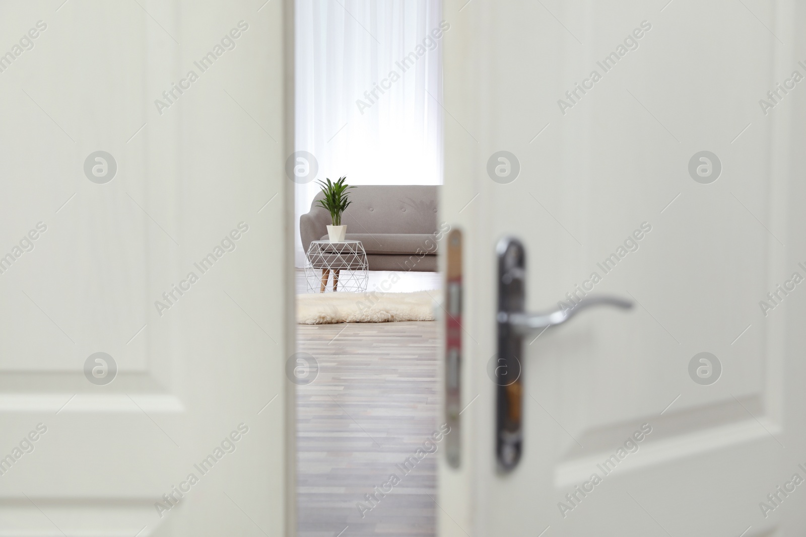 Photo of Stylish room interior, view through open door