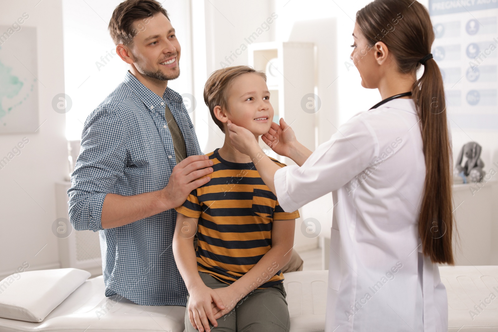 Photo of Father with child visiting doctor in hospital