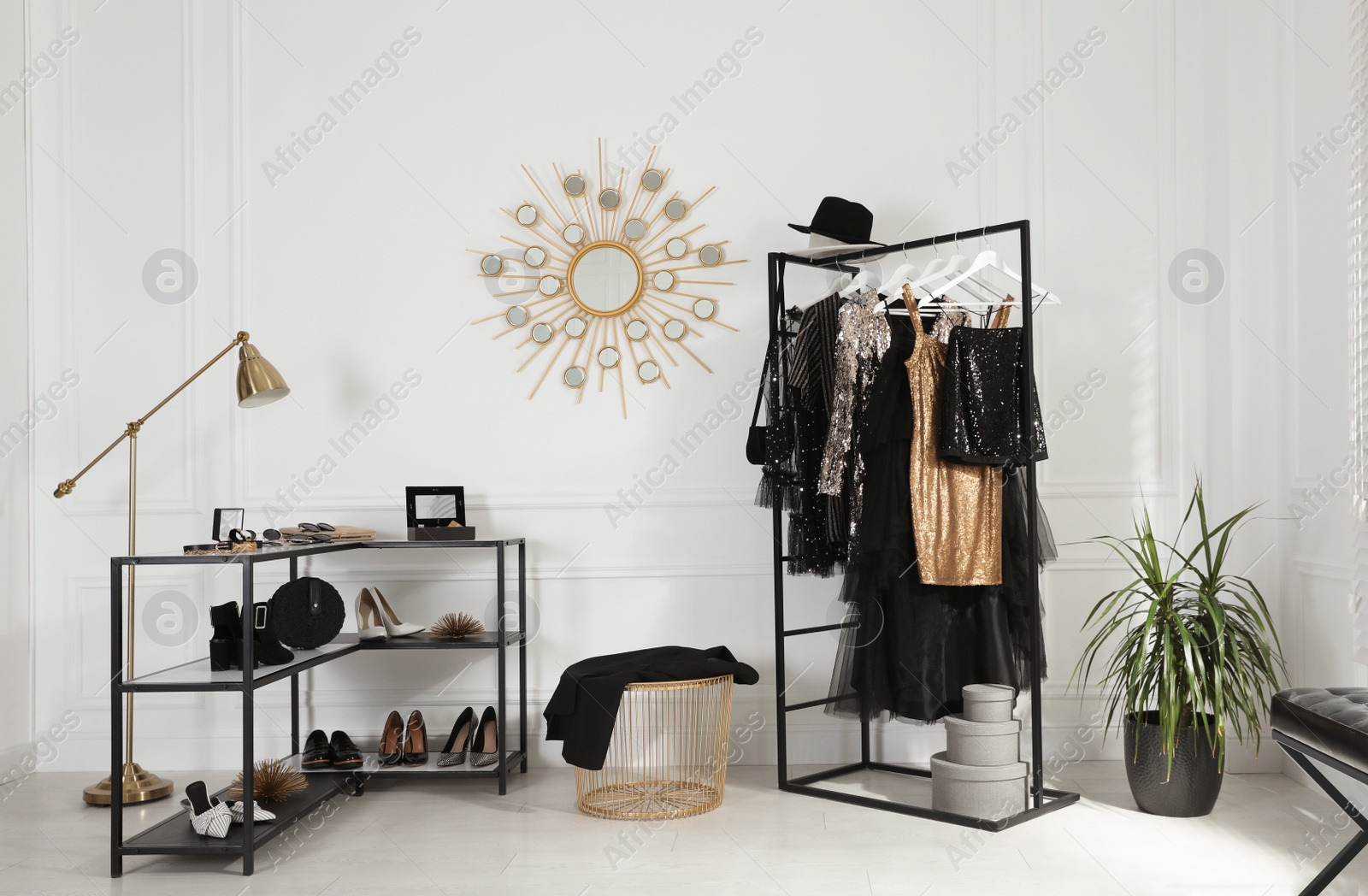 Photo of Stylish dressing room interior with trendy clothes, shoes and accessories