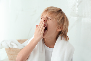 Cute little boy yawning in bathroom. Bedtime