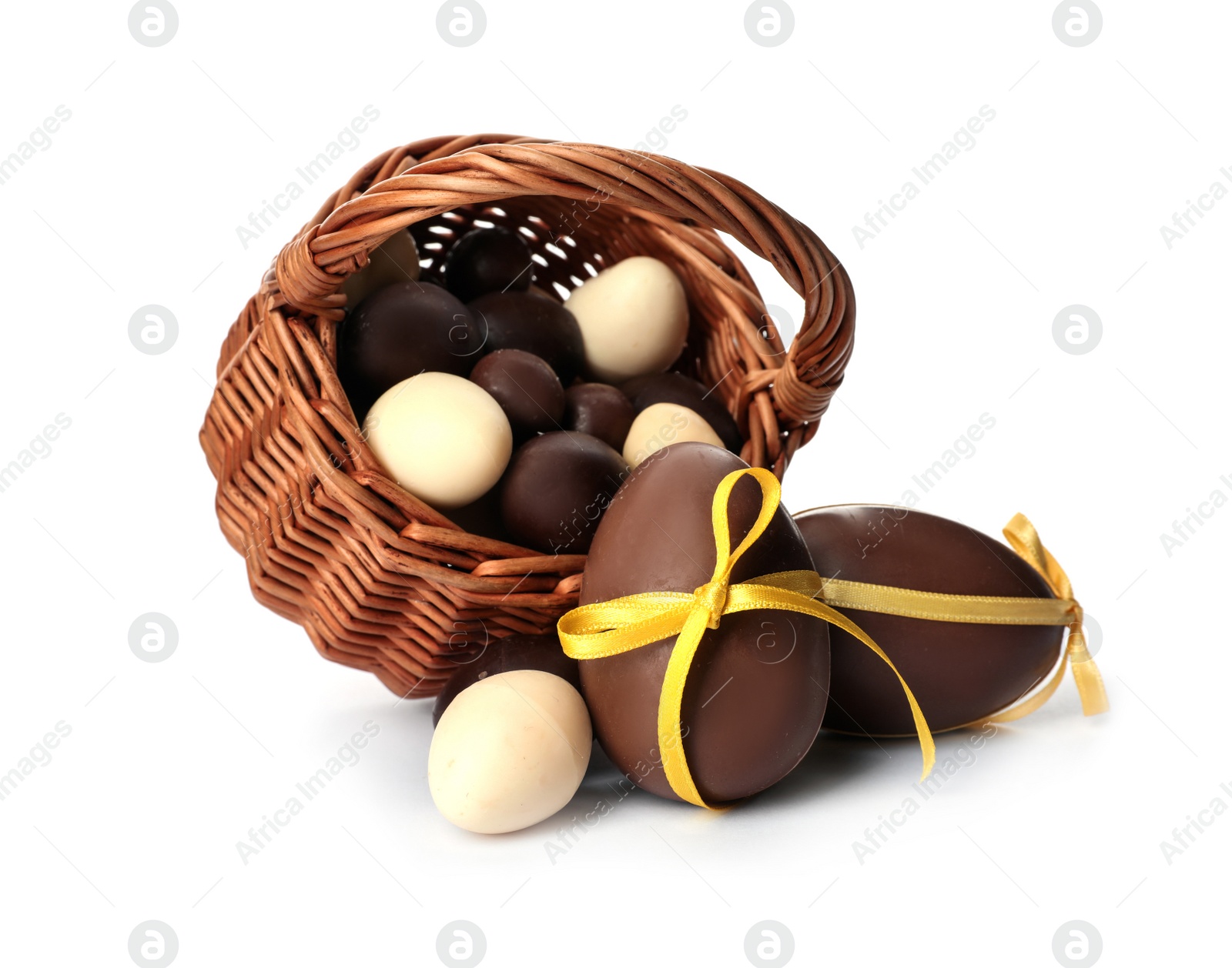 Photo of Wicker basket with sweet chocolate Easter eggs on white background