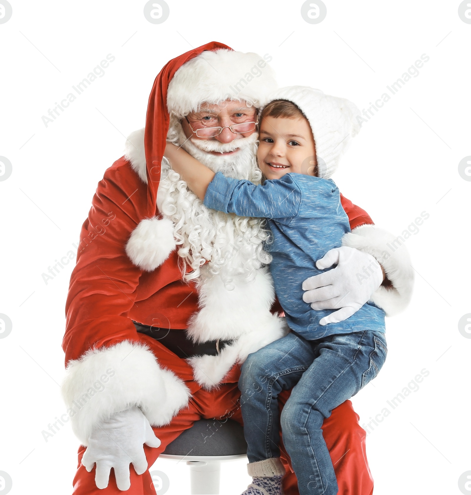 Photo of Little boy hugging authentic Santa Claus on white background