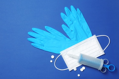 Photo of Flat lay composition with medical gloves on color background