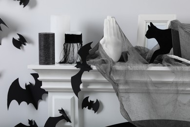 Different Halloween decor on fireplace in room