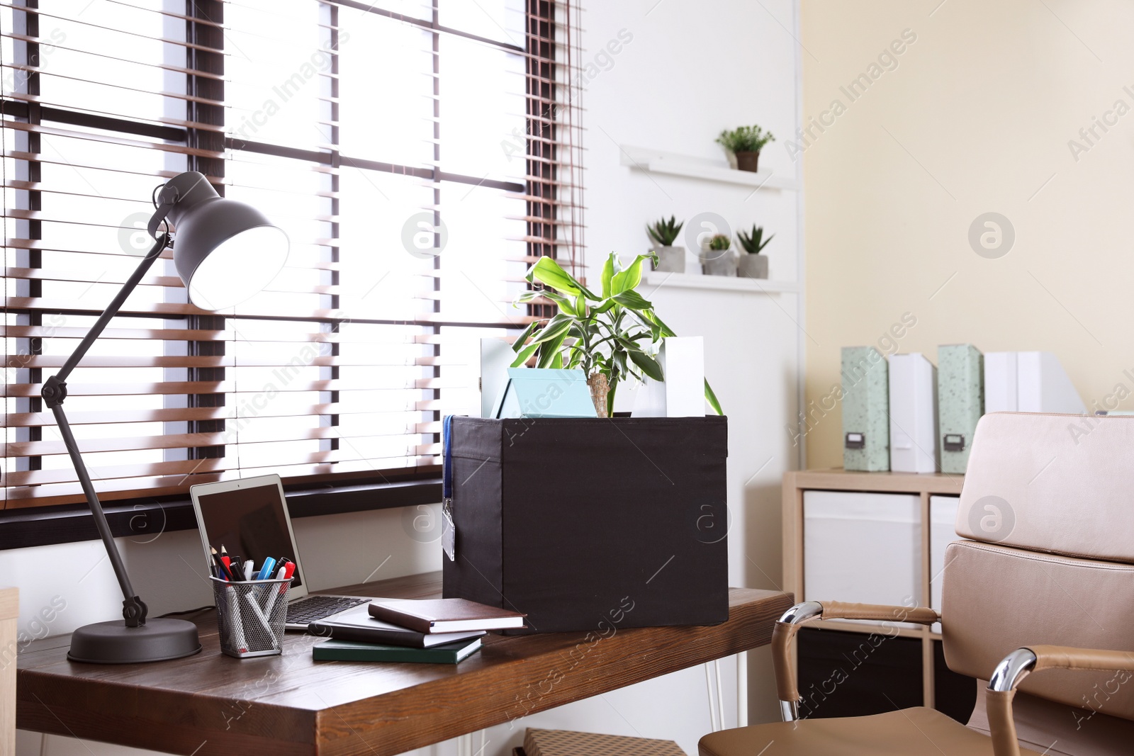 Photo of Moving box on desk in office. Work promotion concept