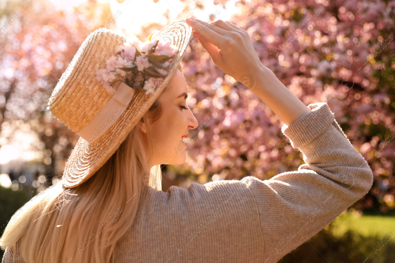 Photo of Young woman wearing stylish outfit in park on spring day. Fashionable look