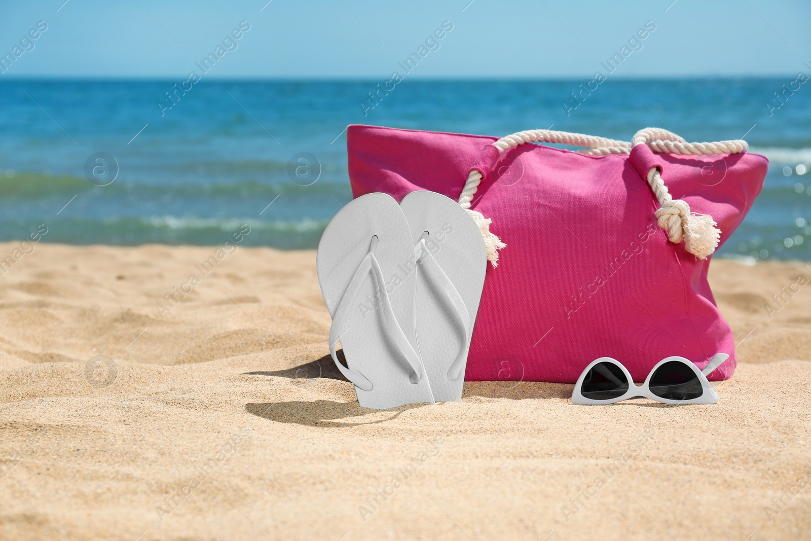 Photo of Set of different beach objects on sand near sea. Space for text