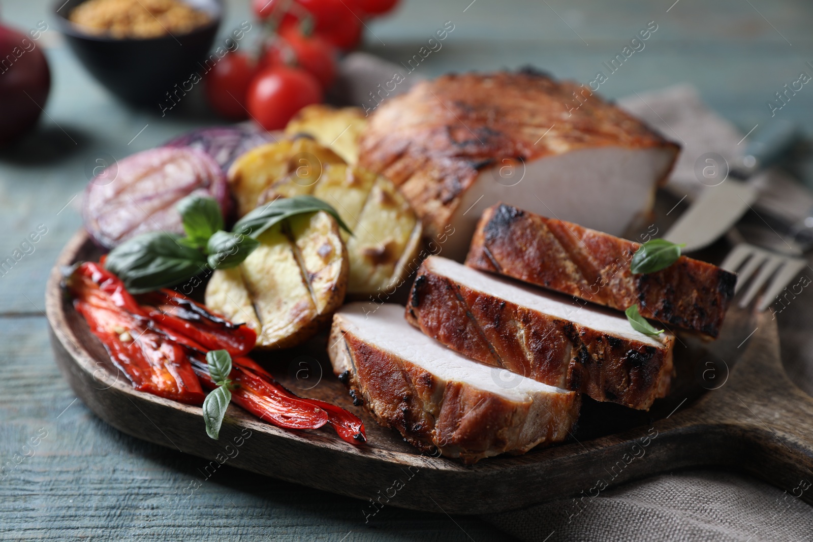 Photo of Delicious grilled meat and vegetables served on wooden table, closeup