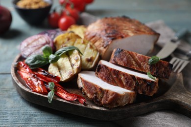 Delicious grilled meat and vegetables served on wooden table, closeup