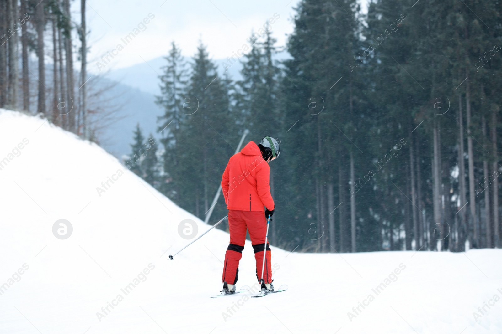 Photo of Skier on slope at resort. Winter vacation