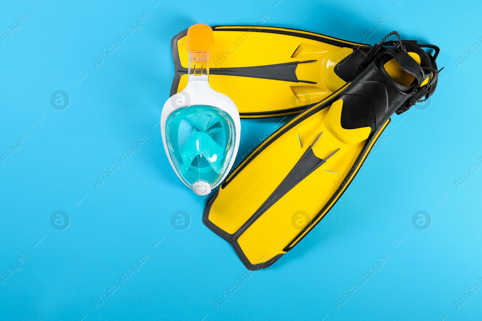 Photo of Swimming flippers and mask on color background, top view. Space for text