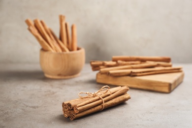 Aromatic cinnamon sticks on grey stone table