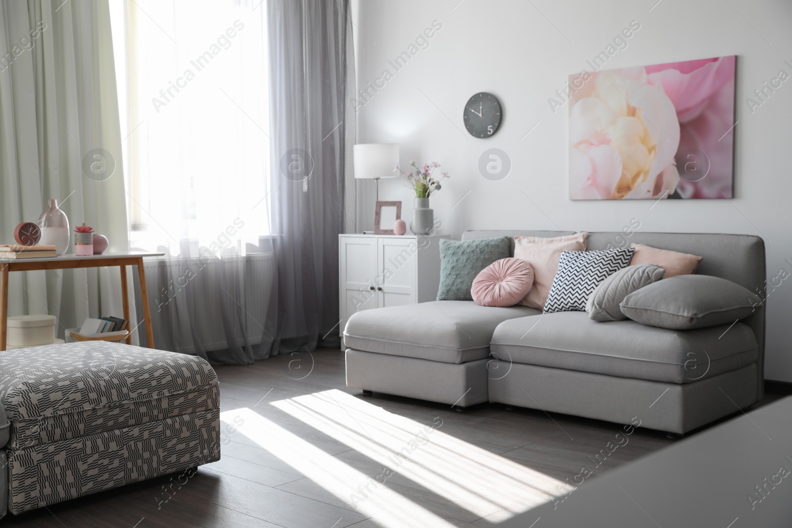 Photo of Elegant living room with comfortable sofa near window. Interior design