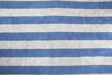 Striped beach towel as background, top view