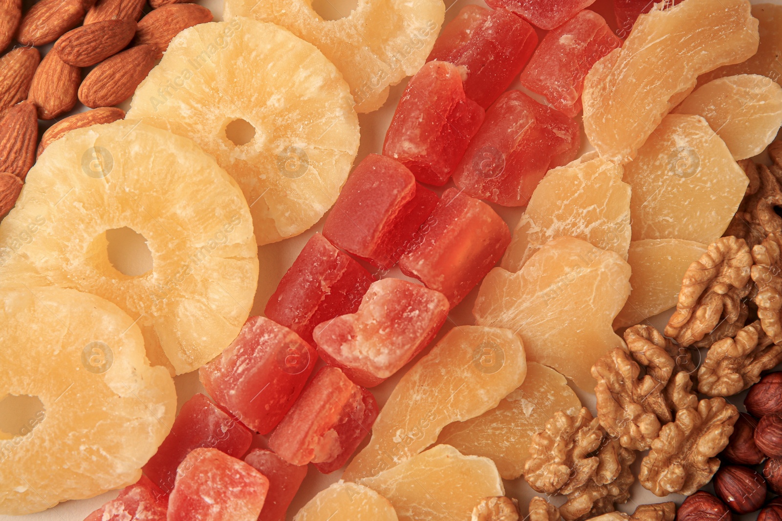 Photo of Different tasty nuts and dried fruits as background, top view