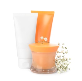Photo of Cosmetic products and flowers on white background