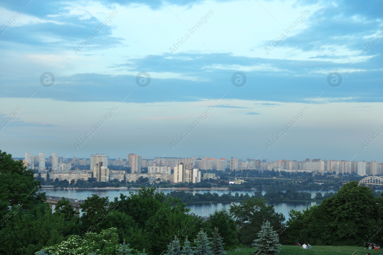 Photo of KYIV, UKRAINE - MAY 23, 2019: Beautiful cityscape with green park and Darnitsky railway bridge