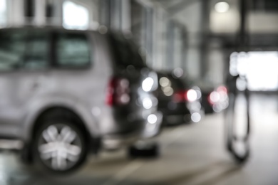 Photo of Blurred view of modern automobile repair shop