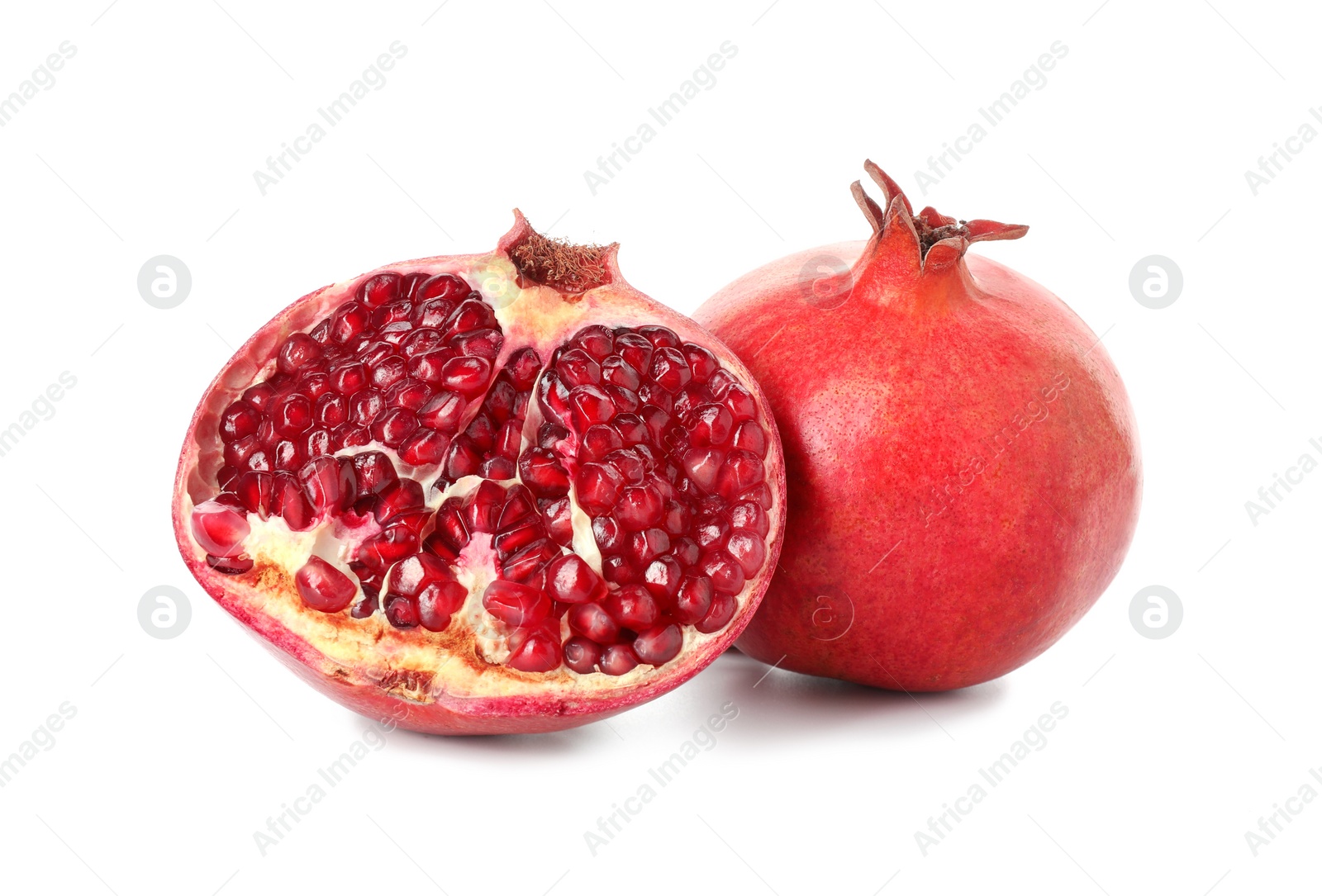 Photo of Half and whole pomegranates isolated on white