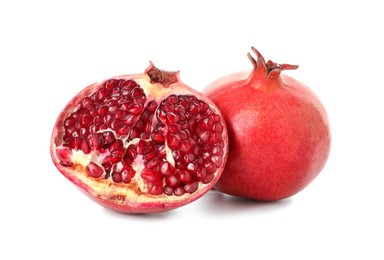 Half and whole pomegranates isolated on white