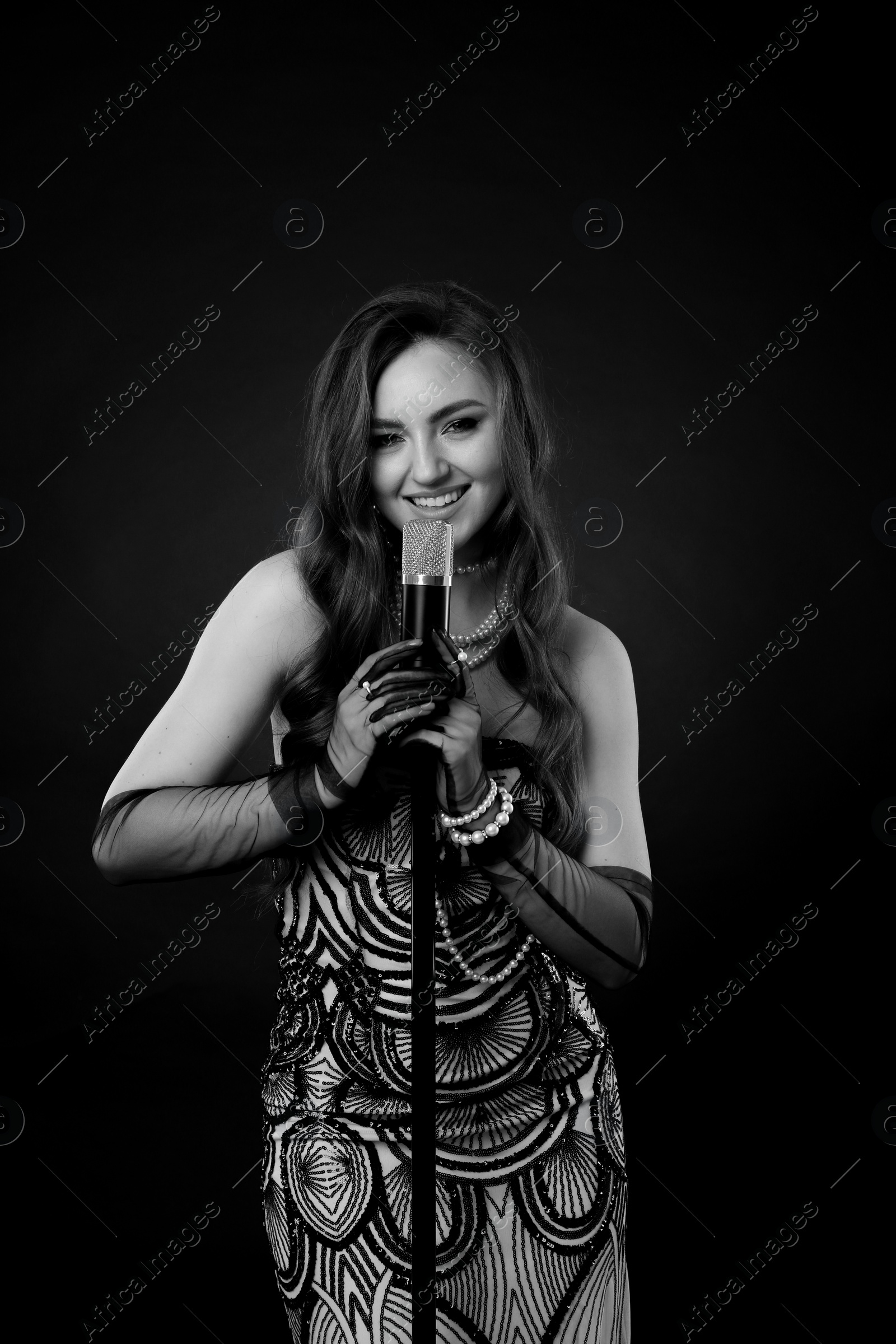 Image of Beautiful singer with microphone, black and white effect