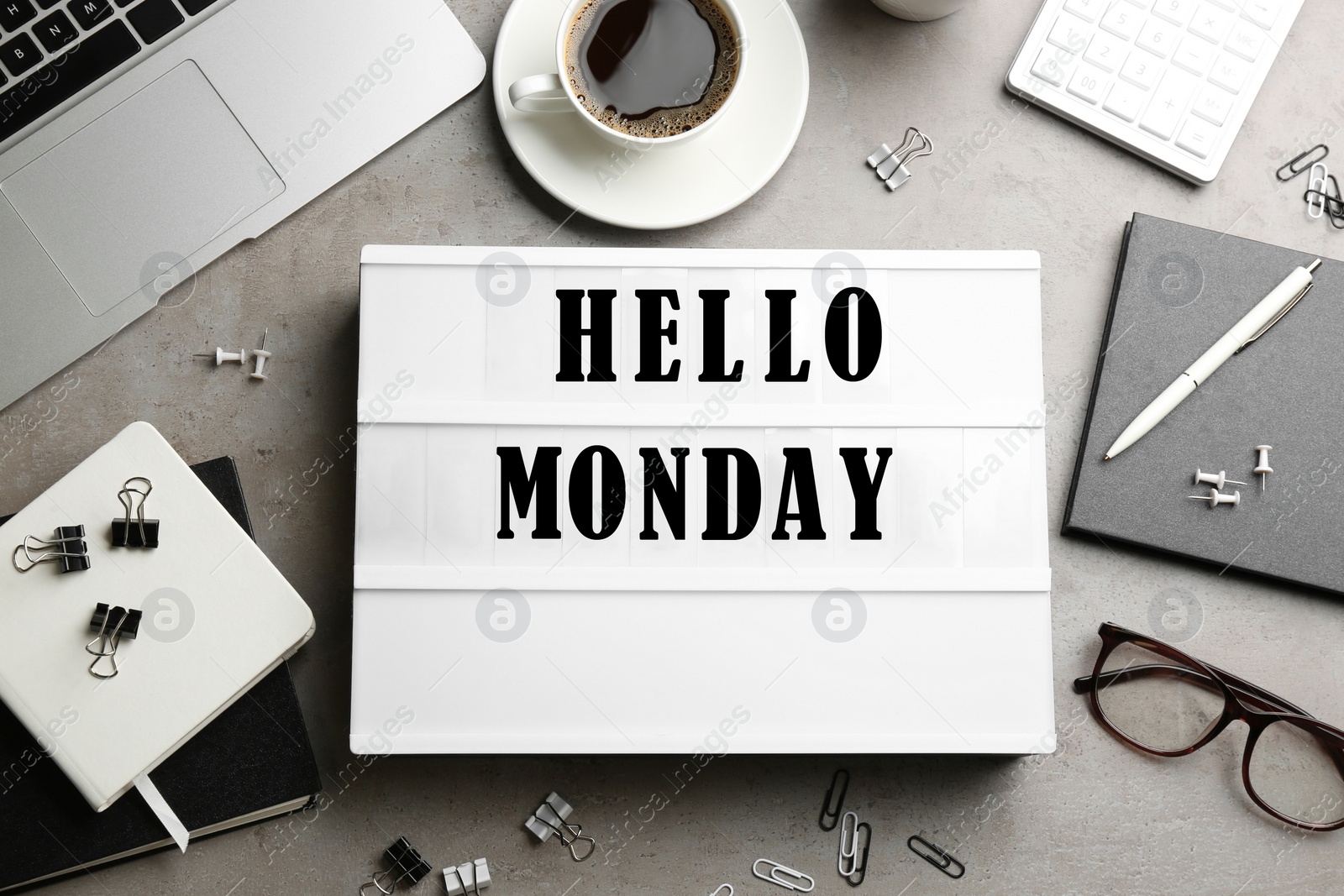 Image of Hello Monday, start your week with good mood. Flat lay composition with lightbox and office supplies on grey table