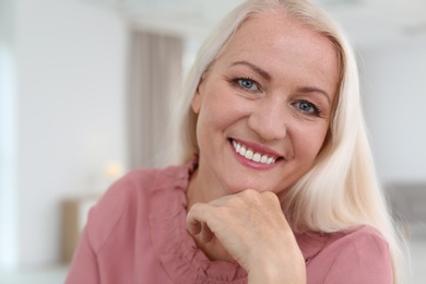 Portrait of beautiful older woman against blurred background