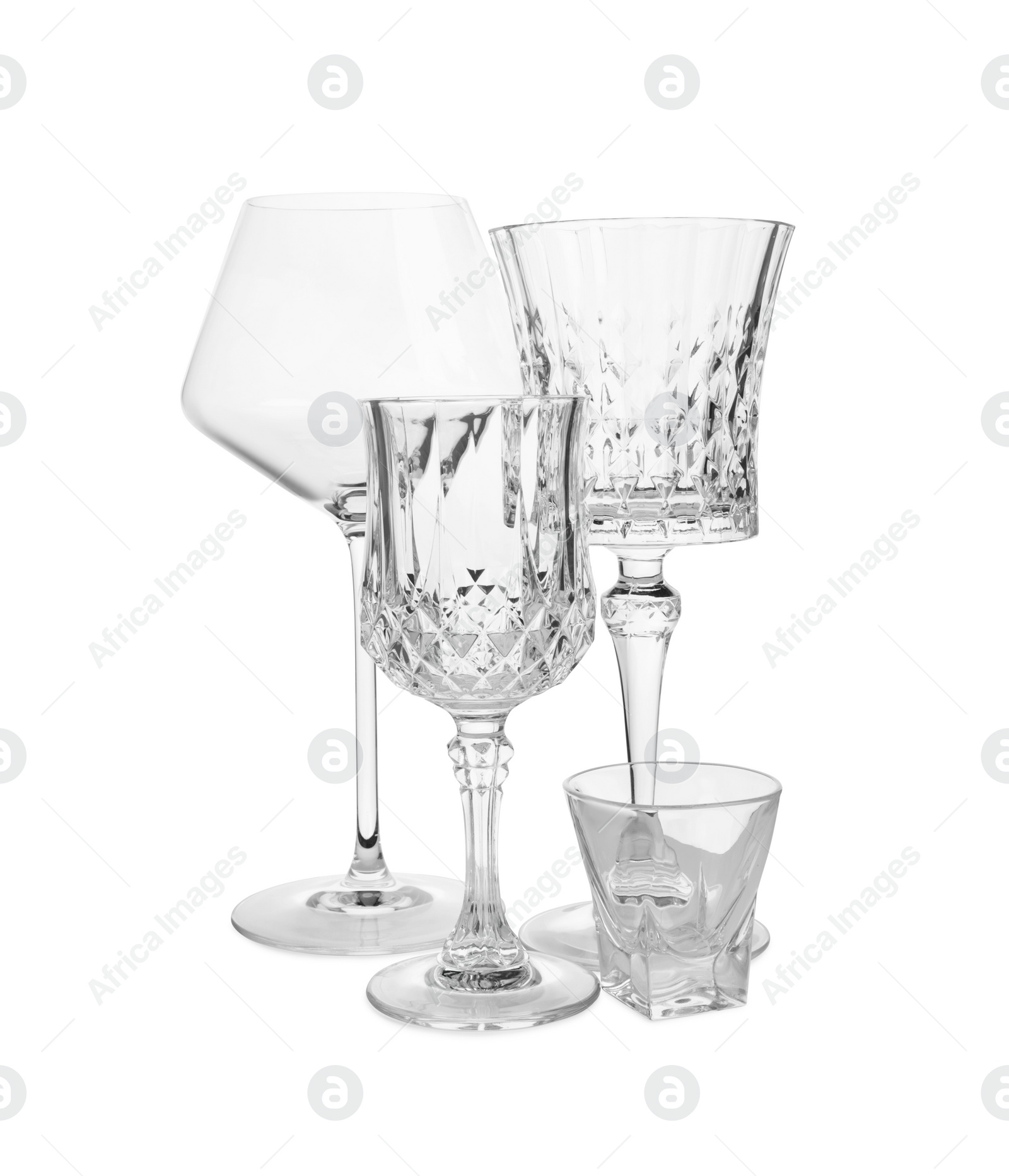 Photo of Different elegant empty wine and shot glasses isolated on white