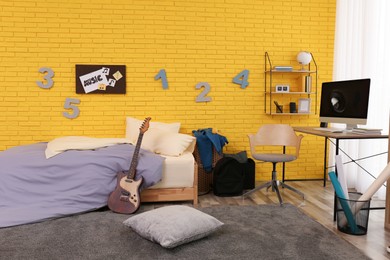 Stylish teenager's room interior with computer and bed