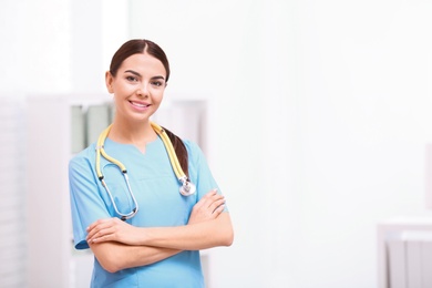 Portrait of medical assistant with stethoscope in hospital. Space for text