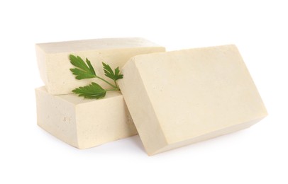 Photo of Blocks of delicious raw tofu with parsley on white background