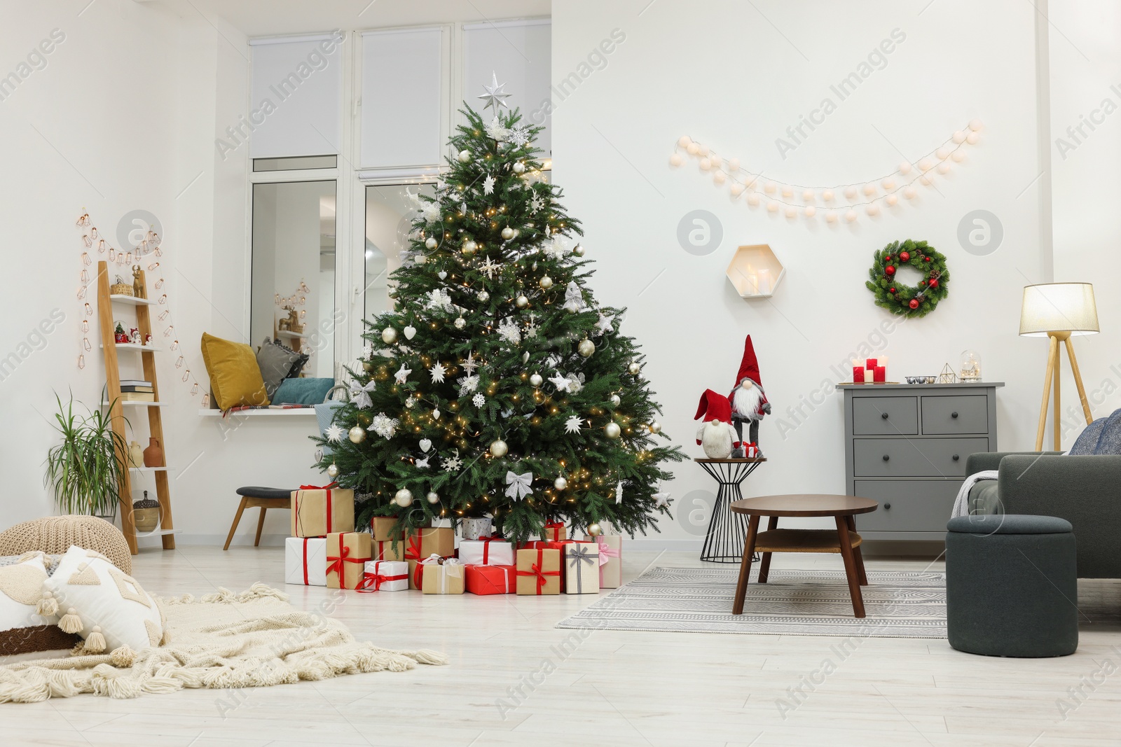 Photo of Beautiful Christmas tree and gift boxes in living room. Interior design