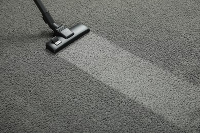 Photo of Vacuuming grey carpet. Clean area after using device. Space for text