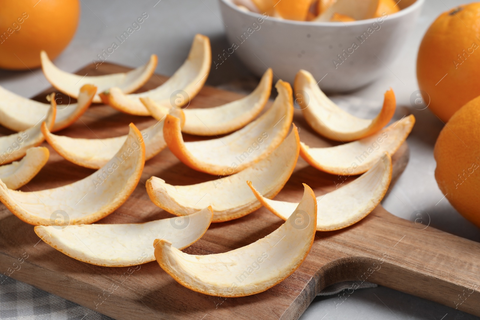 Photo of Many orange peels preparing for drying on grey table, closeup