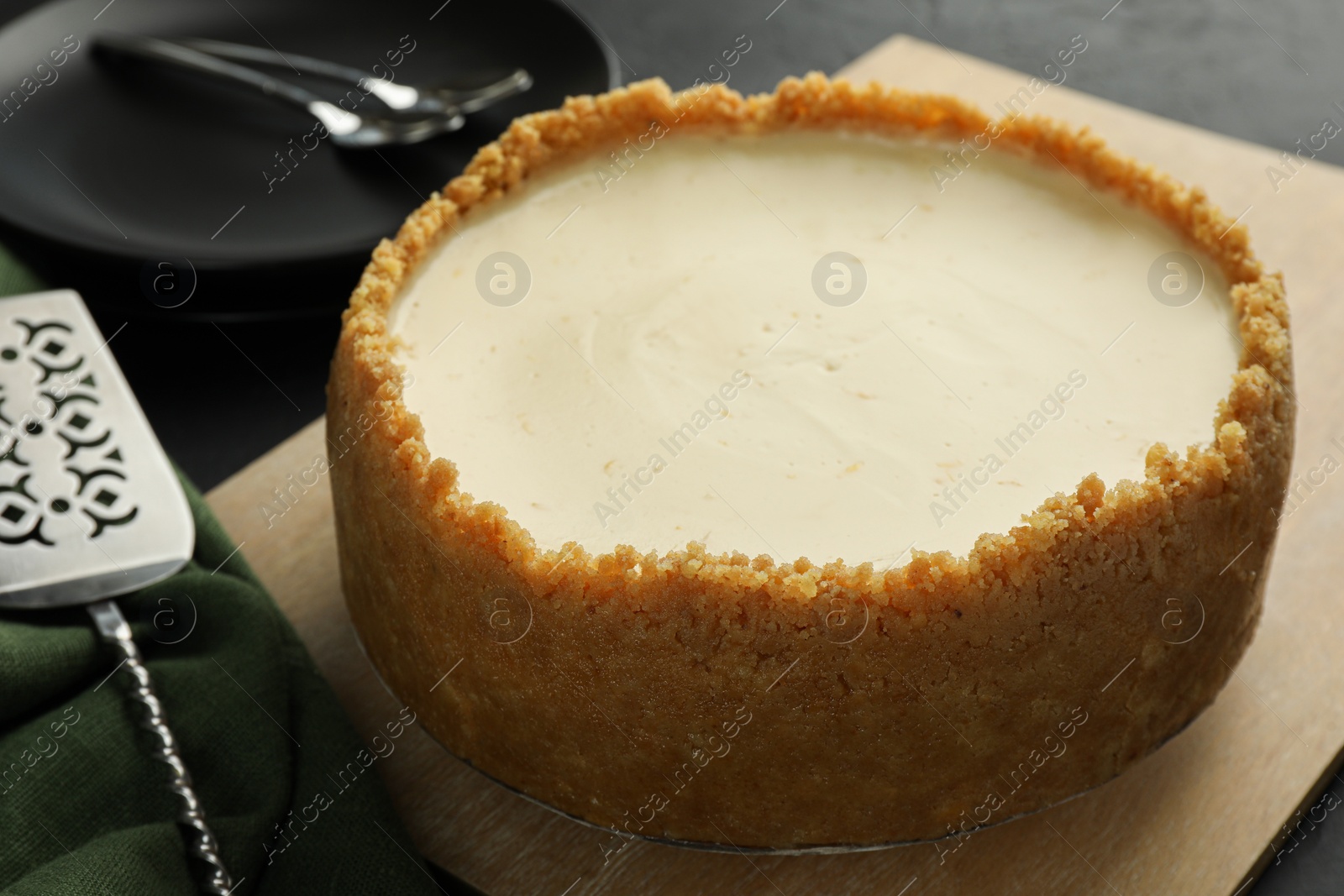 Photo of Tasty vegan tofu cheesecake served on dark table