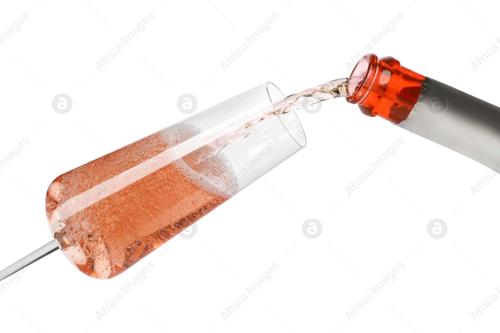 Photo of Rose champagne pouring from bottle into glass isolated on white