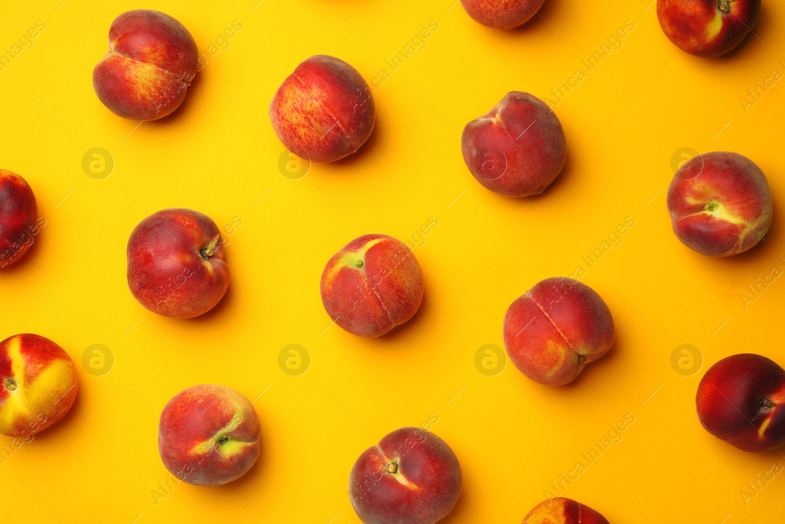 Photo of Flat lay composition with ripe peaches on orange background