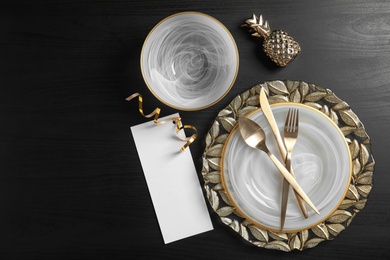 Photo of Elegant table setting and space for text on dark background, top view