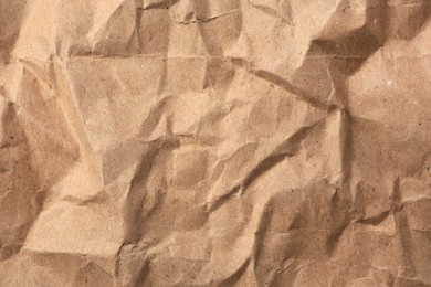 Sheet of crumpled kraft paper as background, top view