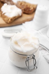 Photo of Delicious pork lard in glass jar on white table, closeup