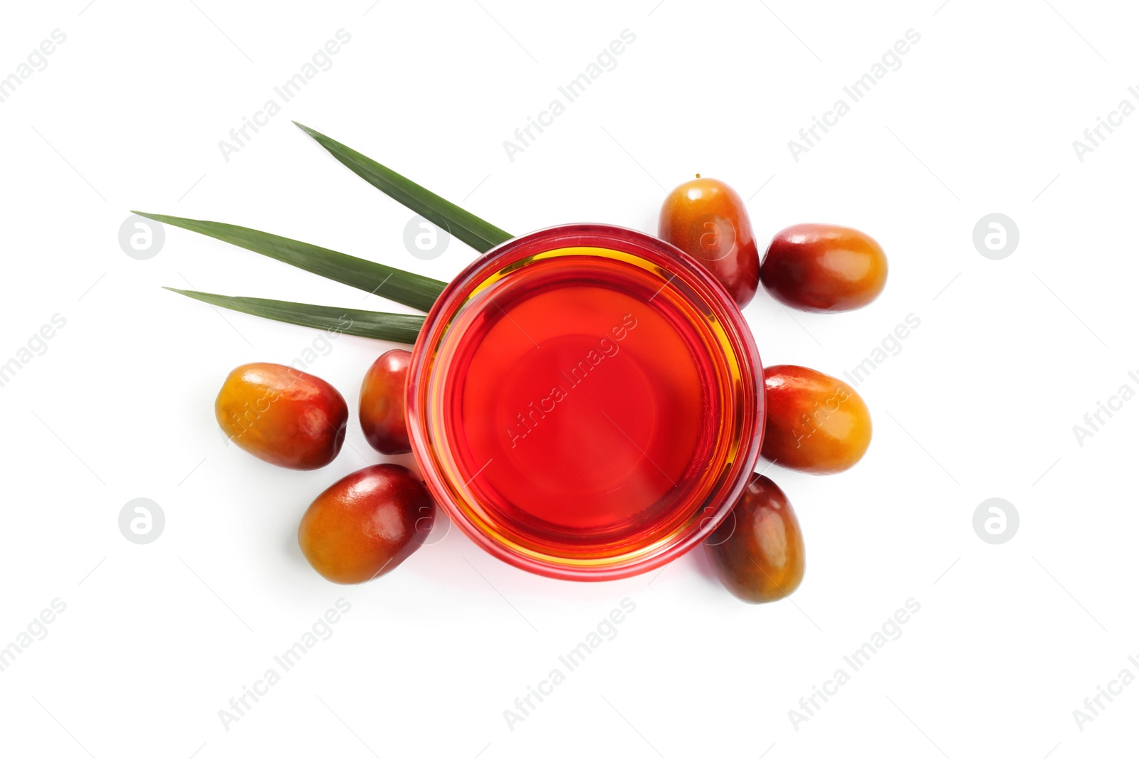 Photo of Palm oil in glass bowl, tropical leaf and fruits isolated on white, top view